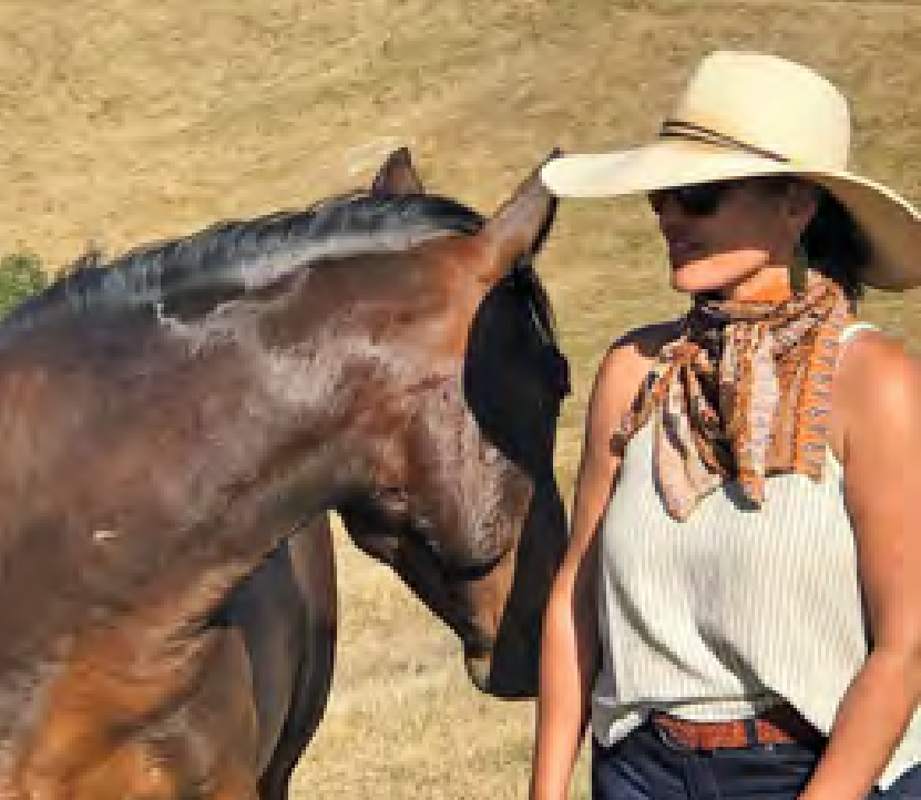 a woman with a dark horse at Horse and Heart Ranch